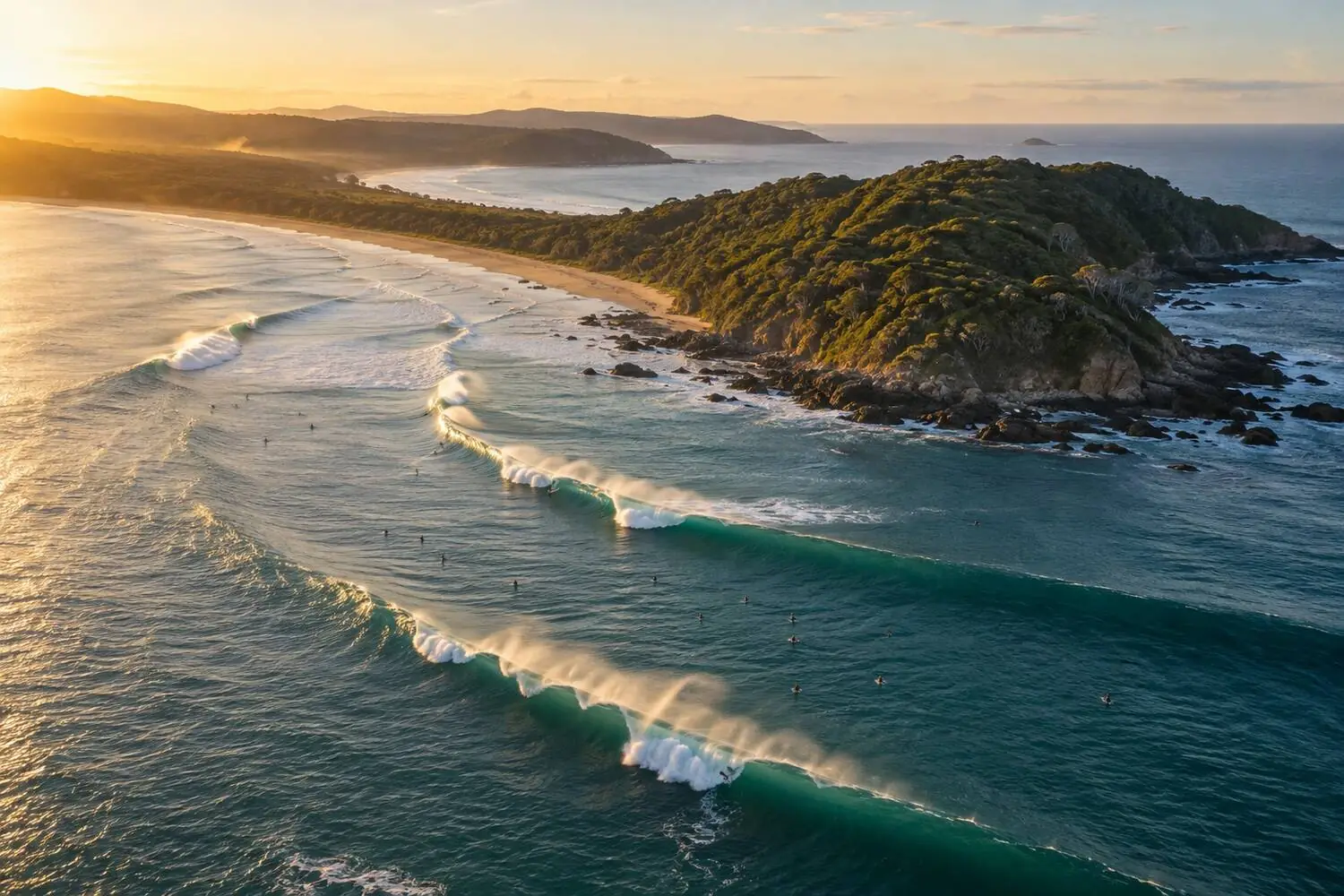 An aerial view of a point break wrapping along a headland on the Australian coast